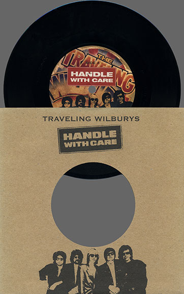 Traveling Wilburys - Handle With Care (Wilbury/Rhino RHI7-198908) –  inserting a single into an envelope from above